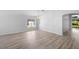 Spacious living area featuring wood flooring, neutral walls, and plenty of natural light at 707 Stonewyk Way, Kissimmee, FL 34744