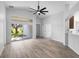 Open-concept living room featuring modern flooring and vaulted ceilings at 707 Stonewyk Way, Kissimmee, FL 34744