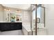 Spacious bathroom showcasing a soaking tub, double vanity with modern fixtures, and a glass-enclosed shower at 753 Lake Dell Ave, Dundee, FL 33838