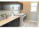 Well-appointed laundry room featuring cabinetry, ample counter space, modern appliances, and a utility sink at 753 Lake Dell Ave, Dundee, FL 33838