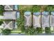 An aerial view showcases private pools with screened enclosures in a neighborhood with mature trees and roof tops at 7745 Comrow St, Kissimmee, FL 34747