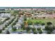 A birds eye view of a tree-lined residential neighborhood with mature trees near shopping centers and commercial districts at 7745 Comrow St, Kissimmee, FL 34747