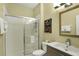 Cozy bathroom features a walk-in shower, modern sink and fixtures, and decorative wall art at 7745 Comrow St, Kissimmee, FL 34747