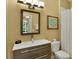 Modern bathroom with a sleek vanity, decorative mirror, and a neutral color scheme at 7745 Comrow St, Kissimmee, FL 34747