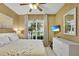 Comfortable bedroom with natural light, a ceiling fan, light wood floors, and neutral-toned walls at 7745 Comrow St, Kissimmee, FL 34747