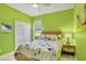 Bright green bedroom featuring a ceiling fan, natural light, and a closet at 7745 Comrow St, Kissimmee, FL 34747