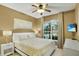 Comfortable bedroom with natural light, a ceiling fan, light wood floors, and neutral-toned walls at 7745 Comrow St, Kissimmee, FL 34747