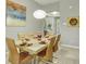 Dining room features seating for six, art on the walls, and a modern chandelier at 7745 Comrow St, Kissimmee, FL 34747