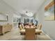 Bright dining room with chandelier, seating for six, and a seamless flow into the living room at 7745 Comrow St, Kissimmee, FL 34747