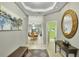 Inviting home entryway with modern decor, light wood floors, an elegant foyer, and views to the living area at 7745 Comrow St, Kissimmee, FL 34747