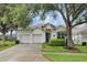 Charming single-Gathering home featuring a well-maintained lawn, mature trees, and a spacious three-car garage at 7745 Comrow St, Kissimmee, FL 34747