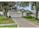 Charming single-story home with a two car garage, well-manicured lawn and lush landscaping at 7745 Comrow St, Kissimmee, FL 34747