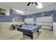 Recreation room with pool table, air hockey, tall garage doors and high ceilings at 7745 Comrow St, Kissimmee, FL 34747