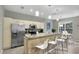 Bright kitchen featuring stainless steel appliances, granite counters, and breakfast bar at 7745 Comrow St, Kissimmee, FL 34747