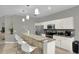 Well-lit kitchen boasts stainless steel appliances, granite counters and light cabinetry at 7745 Comrow St, Kissimmee, FL 34747