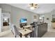 Bright living area with comfortable leather seating, a flat-screen television and backyard views at 7745 Comrow St, Kissimmee, FL 34747