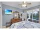 Bright main bedroom with access to the lanai offers a relaxing retreat at 7745 Comrow St, Kissimmee, FL 34747