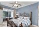 Serene main bedroom features a ceiling fan and sliding doors to the screened lanai at 7745 Comrow St, Kissimmee, FL 34747