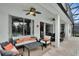 Spacious outdoor patio with comfortable seating, dark-stained furniture, and ceiling fans at 7745 Comrow St, Kissimmee, FL 34747