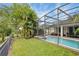 Enjoy your own private screened-in pool with an adjacent patio and a lush green lawn at 7745 Comrow St, Kissimmee, FL 34747