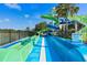 Dual racing water slides with green and blue curves, set against a sunny, tropical backdrop at 7745 Comrow St, Kissimmee, FL 34747