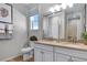 Bathroom featuring double sinks, wood-look floors, and a large mirror at 811 Lake Dell Rd, Dundee, FL 33838