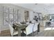 Open dining space featuring stylish decor and a view of the kitchen and living area for seamless entertaining at 811 Lake Dell Rd, Dundee, FL 33838