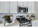 Modern kitchen with stainless steel appliances, white subway tile backsplash, and elegant countertops at 811 Lake Dell Rd, Dundee, FL 33838