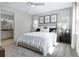 Bright main bedroom features neutral decor, plush carpet and ensuite bathroom view at 811 Lake Dell Rd, Dundee, FL 33838