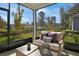 Covered patio featuring comfortable seating and a beautiful view of the landscaped backyard at 811 Lake Dell Rd, Dundee, FL 33838