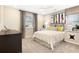 A cozy bedroom features contemporary artwork, a large window with curtains, and carpeted floors at 819 Lake Dell Rd, Dundee, FL 33838