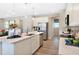 Spacious kitchen boasting stainless steel appliances, island with seating, and abundant natural light at 819 Lake Dell Rd, Dundee, FL 33838