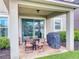 Covered patio with outdoor seating and a grill offers a relaxing outdoor space with privacy at 8635 Tallfield Ave, Orlando, FL 32832