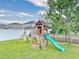 A charming wooden playset with swings and a slide sits in the spacious backyard with a privacy fence at 8635 Tallfield Ave, Orlando, FL 32832