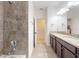 Primary bathroom featuring double sinks, dark cabinetry, and granite countertops at 8635 Tallfield Ave, Orlando, FL 32832