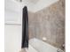 Tiled bathtub with black shower curtain and window at 8635 Tallfield Ave, Orlando, FL 32832