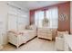 Bedroom with four-poster bed and vintage white dresser at 8635 Tallfield Ave, Orlando, FL 32832