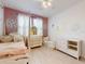 Charming bedroom with a four-poster bed, princess decor and light wood flooring at 8635 Tallfield Ave, Orlando, FL 32832