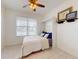 Cozy bedroom with a built-in Murphy bed, complemented by modern flooring and a ceiling fan for added comfort at 8635 Tallfield Ave, Orlando, FL 32832