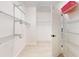A generously sized walk-in closet offers ample shelving and storage space, enhanced by laminate flooring at 8635 Tallfield Ave, Orlando, FL 32832