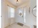Bright foyer featuring light wood-look tile flooring, a stylish light fixture, and a front door with decorative wreath at 8635 Tallfield Ave, Orlando, FL 32832