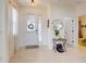 Open foyer showcasing light tile flooring, a round mirror, and a view into other rooms, creating an inviting entrance at 8635 Tallfield Ave, Orlando, FL 32832