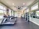 Spacious gym with large windows, ceiling fan, and modern workout equipment, including treadmills and weight machines at 8635 Tallfield Ave, Orlando, FL 32832