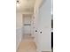 Upstairs hallway with luxury vinyl plank flooring, neutral paint, and access to bathroom at 8635 Tallfield Ave, Orlando, FL 32832