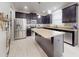 Modern kitchen features stainless steel appliances, granite countertops, an island, and stylish cabinetry at 8635 Tallfield Ave, Orlando, FL 32832