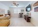 Inviting living room featuring a comfortable couch, a modern ceiling fan, and bright, airy windows at 8635 Tallfield Ave, Orlando, FL 32832