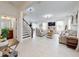 Bright and airy living room with stairs, tile floors, and open concept layout at 8635 Tallfield Ave, Orlando, FL 32832