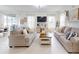 Spacious living room with white tile floors, modern sofas, and rear patio access at 8635 Tallfield Ave, Orlando, FL 32832