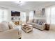 Living room featuring tile floors, neutral sofas, and an entertainment center at 8635 Tallfield Ave, Orlando, FL 32832