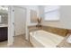 Relaxing main bathroom with a soaking tub, decorative accents, and ample natural light at 8635 Tallfield Ave, Orlando, FL 32832